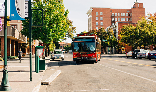 picture of trolley pulling into a bus stop